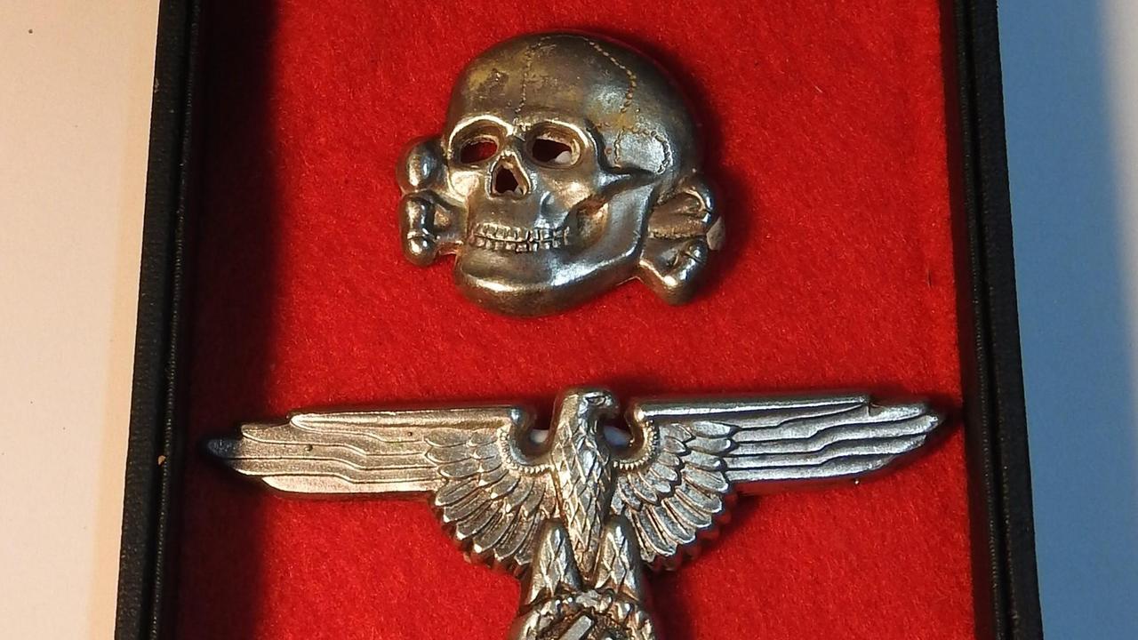 Waffen SS cap insignia Supplied: Danielle Elizabeth Antique &amp; Estate Auctioneers