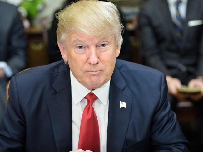 US President Donald Trump waits for a lunch meeting with Harley Davidson executives and union representatives in the Roosevelt Room of the White House February 2, 2017 in Washington, DC. / AFP PHOTO / Brendan Smialowski