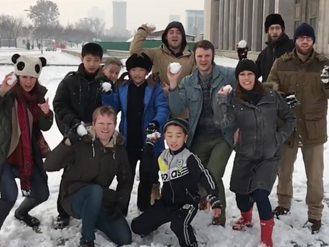 Otto Warmbier (pictured in denim jacket and green pants) is seen here in North Korea. Picture: Supplied