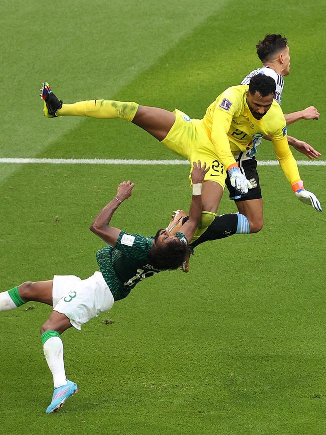 Goalkeeper Mohammed Al-Owais (L) collides with teammate Yasser Al-Shahrani.