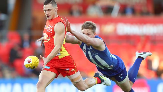 Jack Ziebell tries to chase down Gold Coast’s Ben Ainsworth.