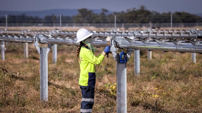 A worker checks metal frames for photovoltaic modules at a solar farm on the outskirts of Gunnedah, New South Wales. Picture: Getty Images