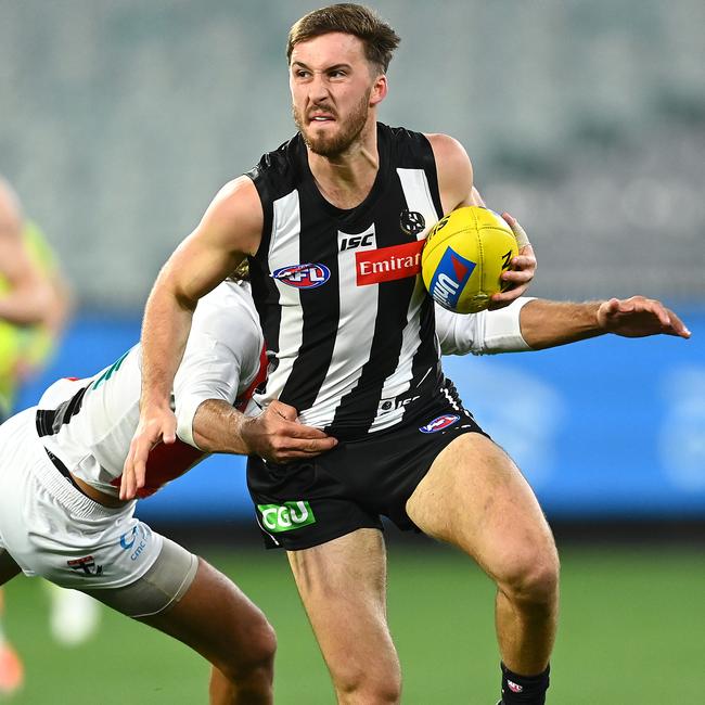 Tom Phillips breaks a tackle from Ben Long. Photo: Quinn Rooney/Getty Images