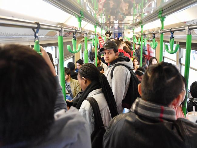 Passengers ride a crowded tram through Swanston St. Picture: Jake Nowakowski