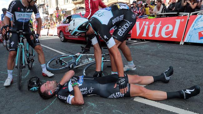 Mark Cavendish lies injured after a fall near the finish line at the end of the 190.5 km first stage of the Tour de France.