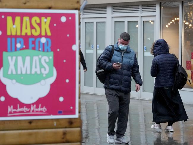 Christmas shoppers walk a past a sign saying 'Mask Up For Christmas’. Picture: Getty Images