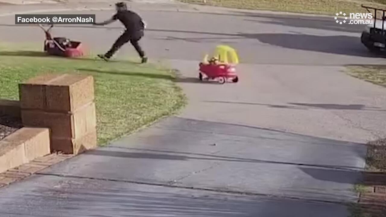 'Dad mode activated' Aussie father juggles his runaway lawnmower and 18-month-old.