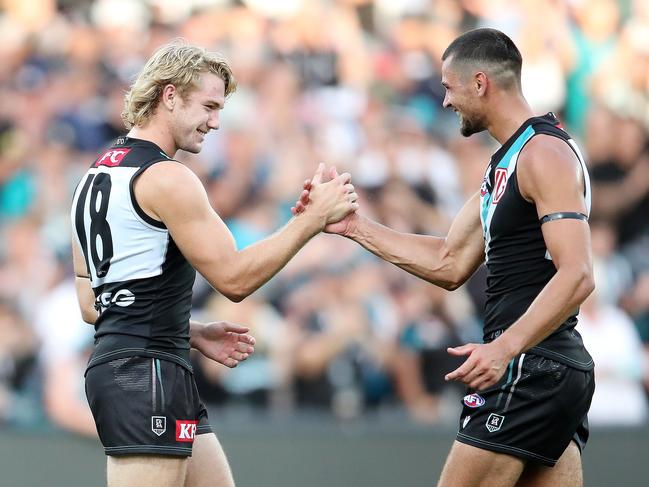 Jason Horne-Francis and Ryan Burton celebrate the Power’s win. (Photo by Sarah Reed/AFL Photos via Getty Images)