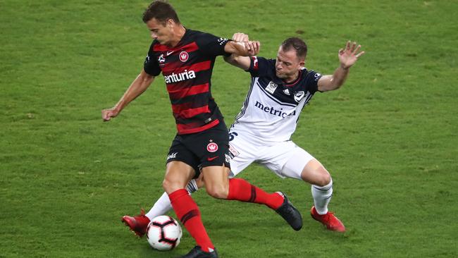 Wanderers striker Oriol Riera takes on Melbourne Victory’s Leigh Broxham