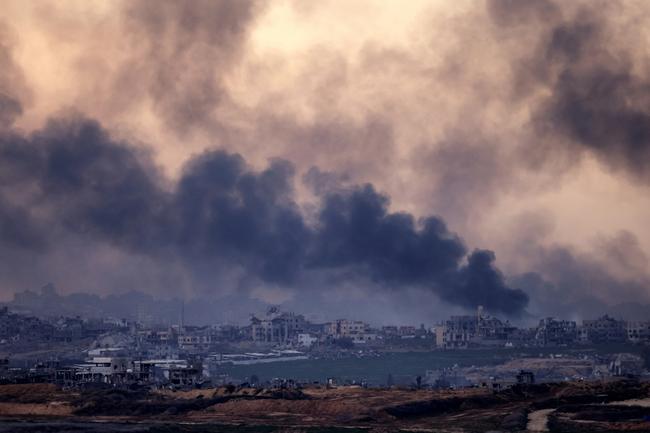 Smoke rises above destroyed buildings in the northern Gaza Strip during an Israeli army bombardment