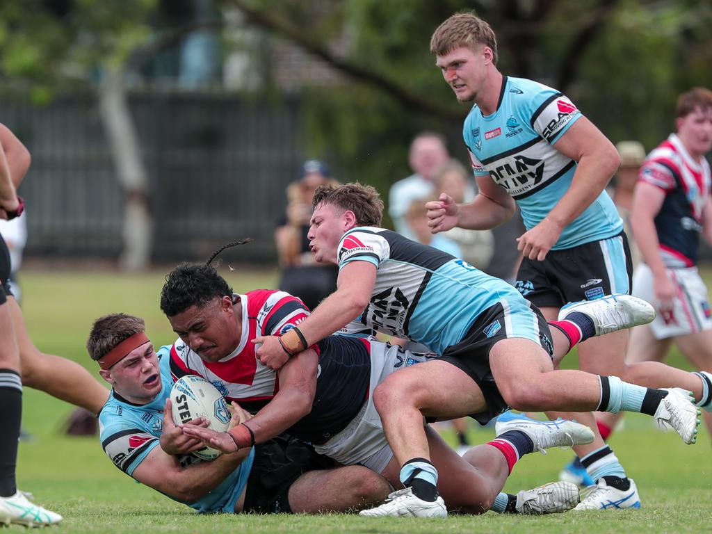 Phillip Lavakeiaho tackled by Thomas Dellow and Alex Challenor. Picture: Adam Wrightson Photography