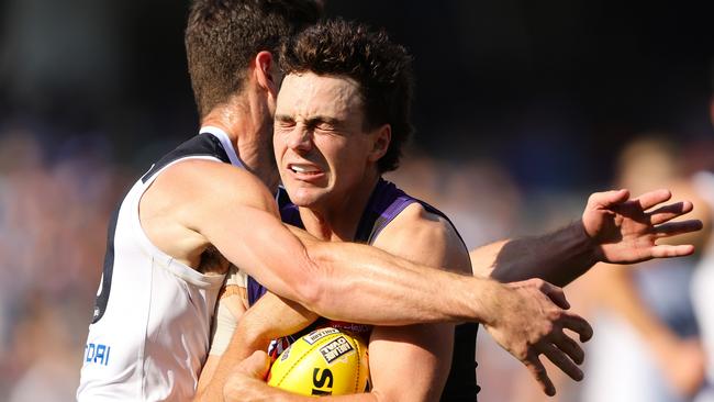 ADELAIDE, AUSTRALIA - APRIL 06: Jordan Clark of the Dockers is tackled by George Hewett of the Blues during the 2024 AFL Round 04 match between the Fremantle Dockers and the Carlton Blues at Adelaide Oval on April 06, 2024 in Adelaide, Australia. (Photo by Sarah Reed/AFL Photos via Getty Images)