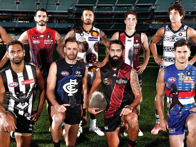 Melbourne teams indigenous players Travis Varcoe, Lindsay Thomas, Jeff Garlett, Andrew Walker, Bradley Hill, Jade Gresham, Courtenay Dempsey, Nakia Cockatoo, Shane Edward and Koby Stevens mdel their teams indgenous round guernsys on the MCG . Pic: Michael Klein