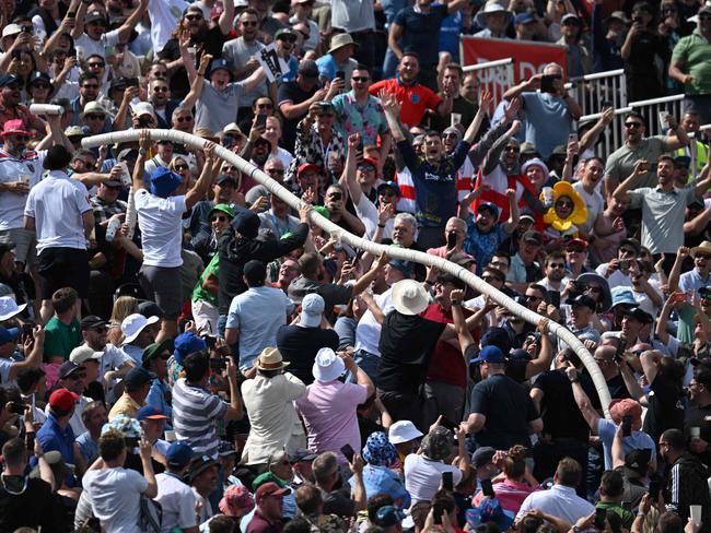 A beer snake appears in the crowd during the fourth Ashes cricket Test match between England and Australia at Old Trafford, Manchester. Picture: Oli Scarff / AFP