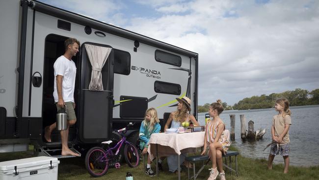 Jade Sutcliffe and Wes Berg (former Australian Ironman) as well as their three young children Miller-May (10), Billie (8) and Tally (4) with their Jayco Expanda Outback caravan. Photographed at Tweed Heads, NSW. Photograph: Russell Shakespeare