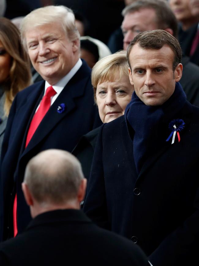 US President Donald Trump (L), German Chancellor Angela Merkel (C) and French President Emmanuel Macron look at Russian President Vladimir Putin at the Paris armistice ceremony.