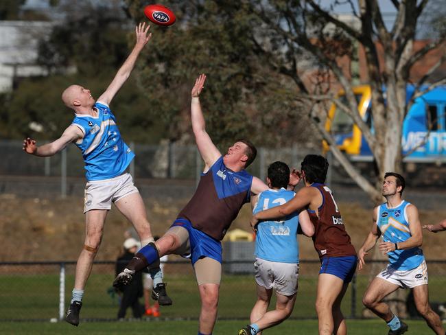 VAFA: Macgregor Cameron of Monash Blues jumps over Ormond’s Liam Adlington. Photo: Hamish Blair