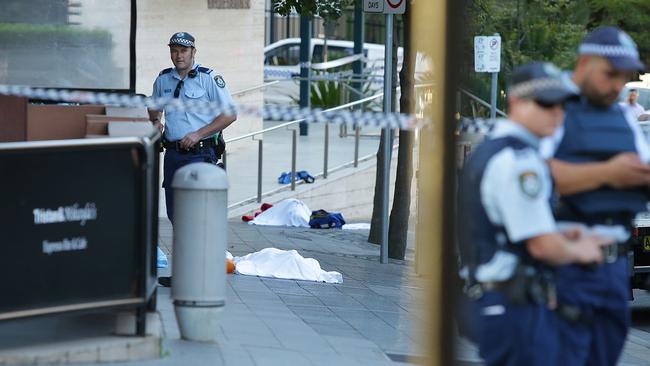 The bodies of Curtis Cheng and Farhad Jabar lie on Charles Street after the Parramatta shooting on Friday night. Picture: Phillip Rogers