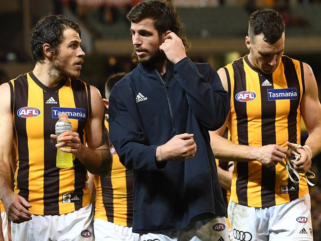 (L-R) Isaac Smith, Ben Stratton and Jonathon Ceglar of the Hawks leave the ground after the First Qualifying Final between the Richmond Tigers and the Hawthorn Hawks in Week 1 of the AFL Finals Series at the MCG in Melbourne, Thursday, September 6, 2018. (AAP Image/Julian Smith) NO ARCHIVING, EDITORIAL USE ONLY