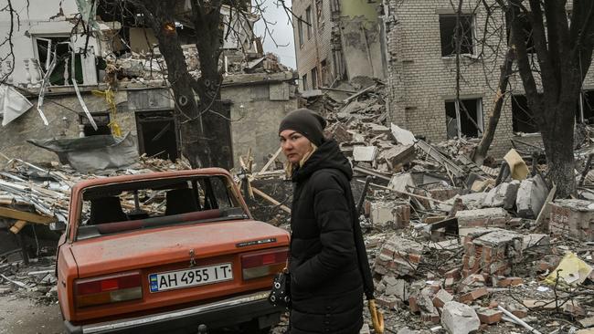 A woman stands in front of a destroyed building after a strike in the city of Sloviansk, Ukraine. Picture: AFP