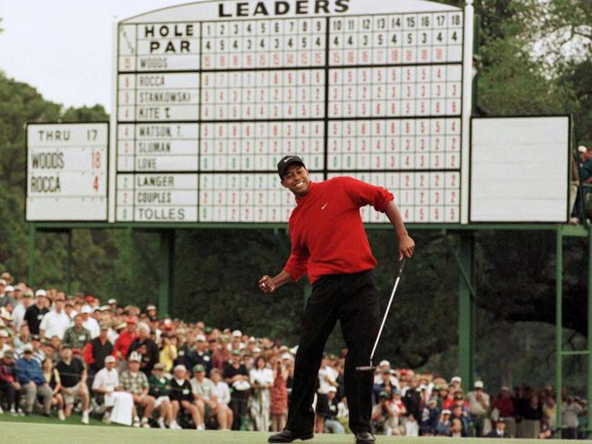 Tiger Woods celebrates victory in the 1997 US Masters on the 18th green of Augusta National Golf Club.