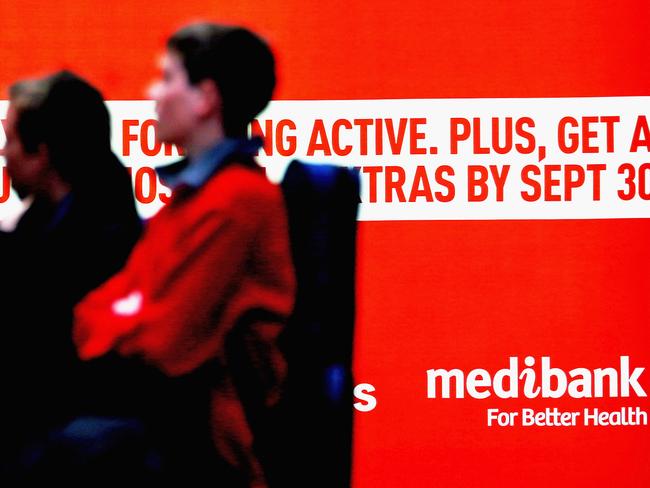 MELBOURNE, AUSTRALIA - OCTOBER 01: People walk past Medibank advertising on October 1, 2014 in Melbourne, Australia. The Abbott government is privatising Australia's largest health insurer, Medibank Private in what will be the biggest Australian initial public offering since 2010. Medibank Private will list on the Australian Stock Exchange in December of this year. (Photo by Scott Barbour/Getty Images)