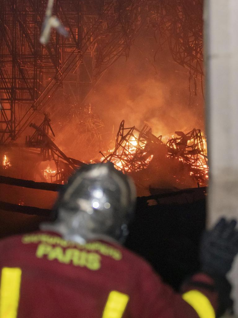 A Paris Fire Brigade firefighter watching the fire inside Notre Dame. Picture: Benoit Moser