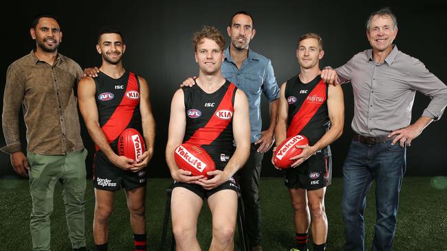 Essendon new recruits reveal what numbers they will wear in the 2018 AFL season: Adam Saad with Nathan Lovett-Murray (No.42), Jack Stringer with Scott Lucas (No.25) and Devon Smith with Terry Daniher (No.5). Picture: Michael Klein