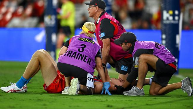 Charlie Ballard is attended to by trainers. Picture: Albert Perez/AFL Photos via Getty Images