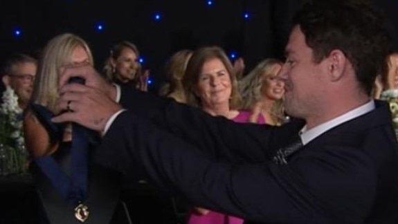 Lachie Neale presents himself the Brownlow Medal.