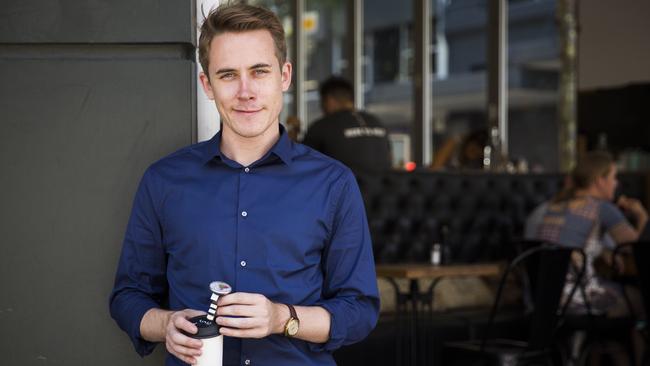 Daily Telegraph journalist Chris Harris measuring coffee temperature at Frothy Cafe, Surry Hills. Picture: Dylan Robinson