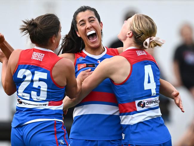 MELBOURNE, AUSTRALIA - SEPTEMBER 22: Jorja Borg of the Bulldogs is congratulated by team mates after kicking a goal during the round four AFLW match between Collingwood Magpies and Western Bulldogs at Victoria Park, on September 22, 2024, in Melbourne, Australia. (Photo by Quinn Rooney/Getty Images)