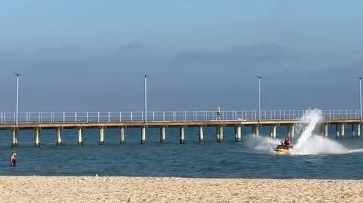 Jet ski hoons come close to swimmers at Rye on the Mornington Peninsula. Picture: Josie Jones