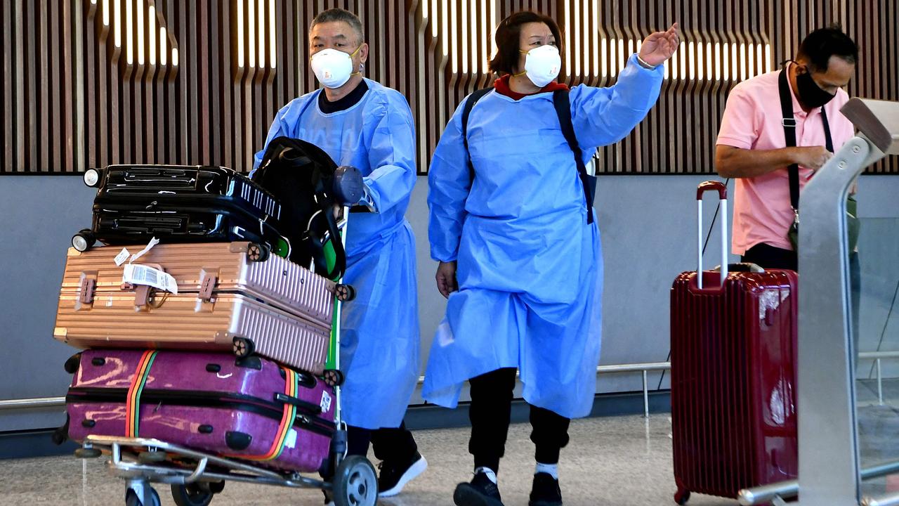 Travellers wearing PPE arrive at Melbourne Airport amid fears around the Omicron variant of Covid-19. Picture: AFP