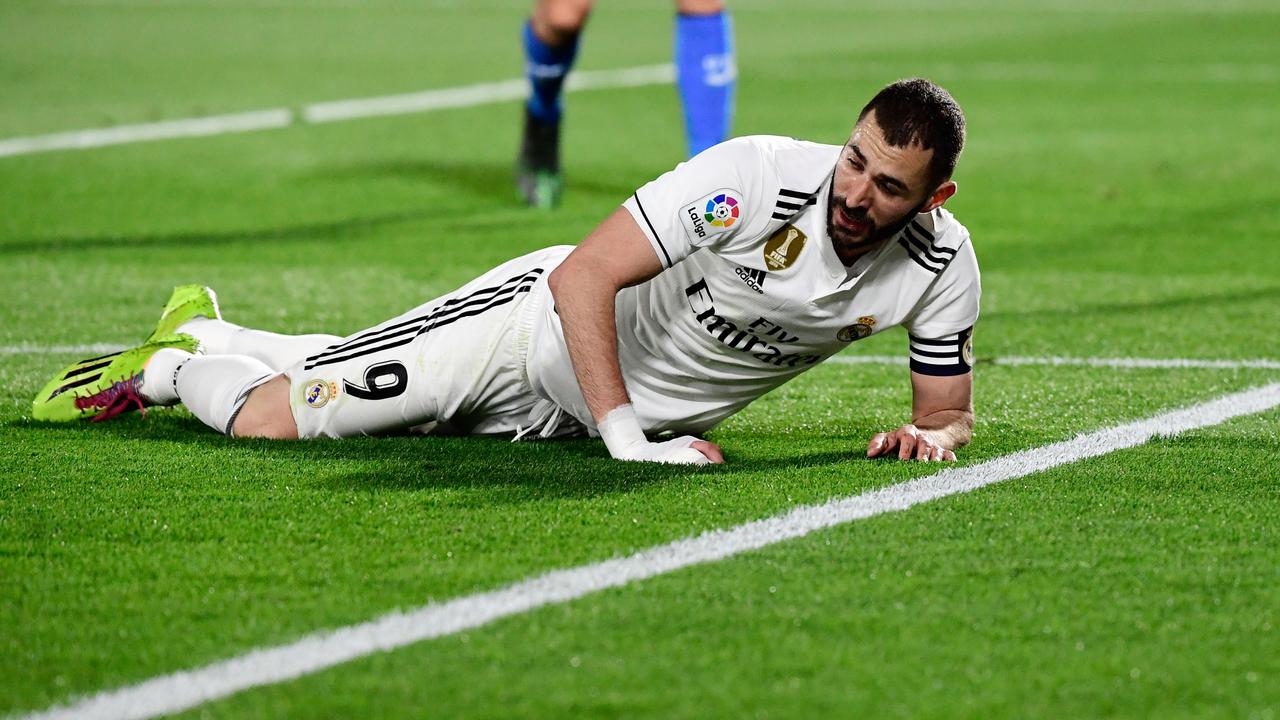 Real Madrid's French forward Karim Benzema lies on the field during the draw with Getafe CF.