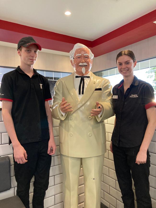 KFC employees Brandyn McDonald and Ashleigh Buoys with the Colonel Sanders statue