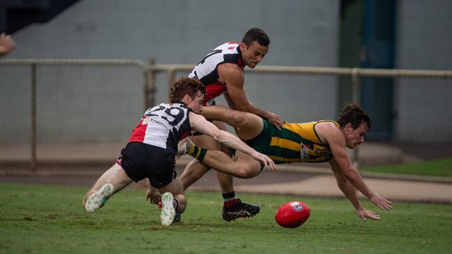 Kyle Kirk being tackled by Dean Staunton and Jordyn Cotter in the Southern Districts vs PINT 2023-24 NTFL men's elimination final. Picture: Pema Tamang Pakhrin