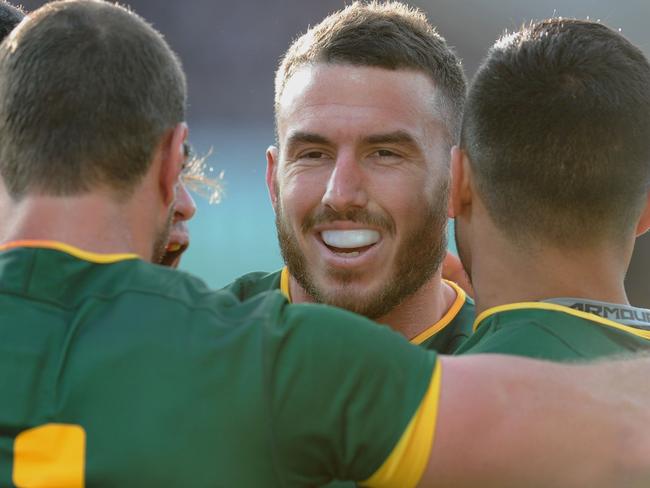 Australia's Darius Boyd (2nd-R) celebrates with teammates after scoring the first try during the Rugby League Test between Australia and New Zealand in Perth on October 15, 2016. / AFP PHOTO / Greg Wood / IMAGE RESTRICTED TO EDITORIAL USE - NO COMMERCIAL USE