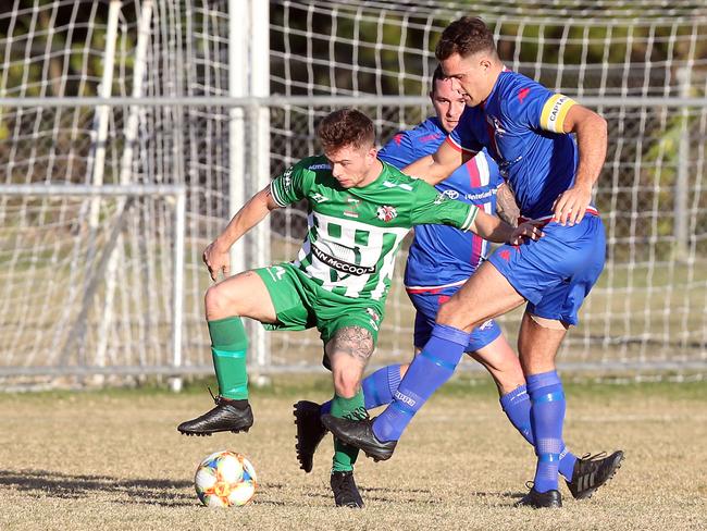 Robina (blue shirts) took on Southport in Gold Coast Premier League round 3 today. Both teams were promoted from a lower league last season and this is the first time they have clashed in the Gold Coast Premier League.Photo of Joe Lamb (green) and Dean Wernerson.Photo by Richard Gosling