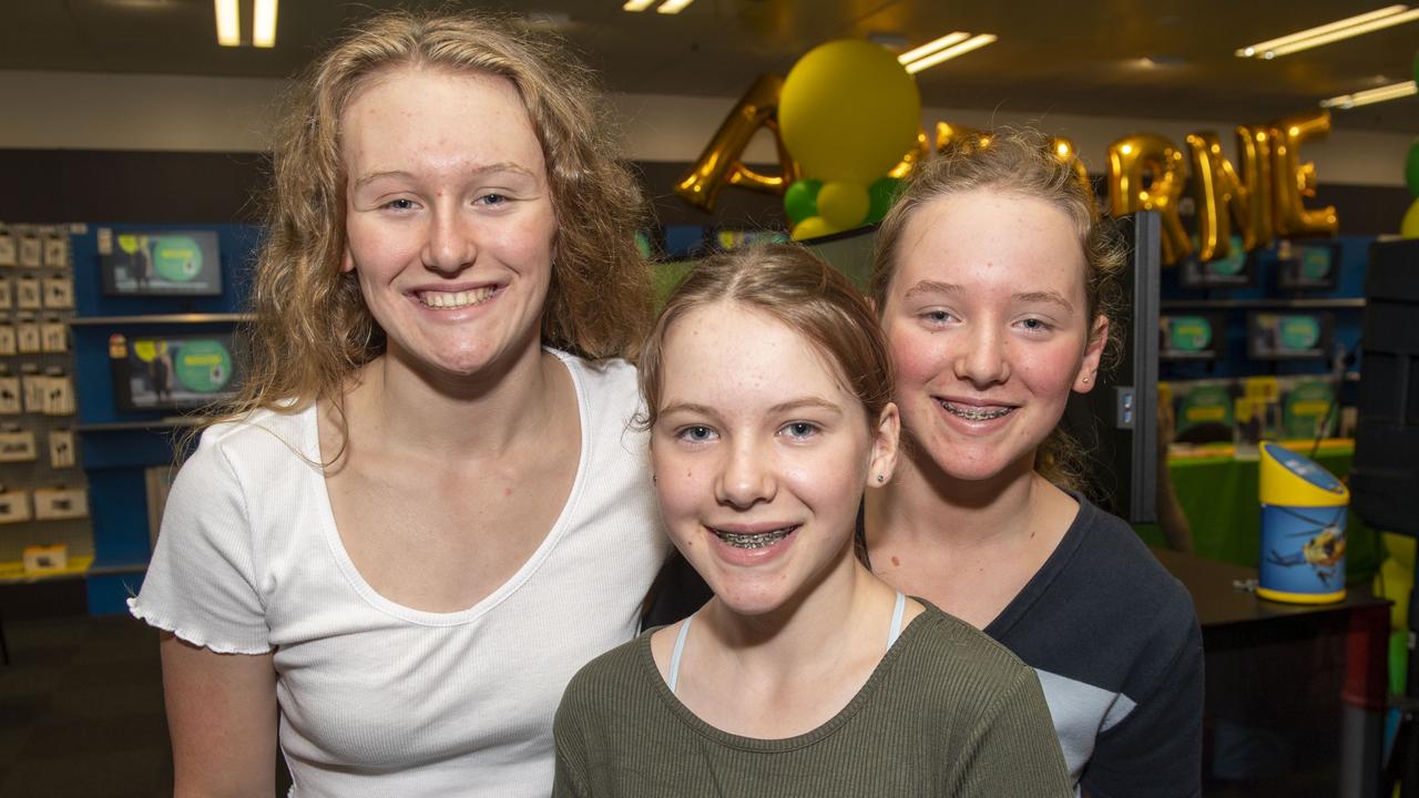 (from left) Romy, Piper and Lilly Wiemers. Fans meet Harvey Norman Brand Ambassador and Olympic Gold Medalist Ariarne Titmus. Saturday, November 20, 2021. Picture: Nev Madsen.