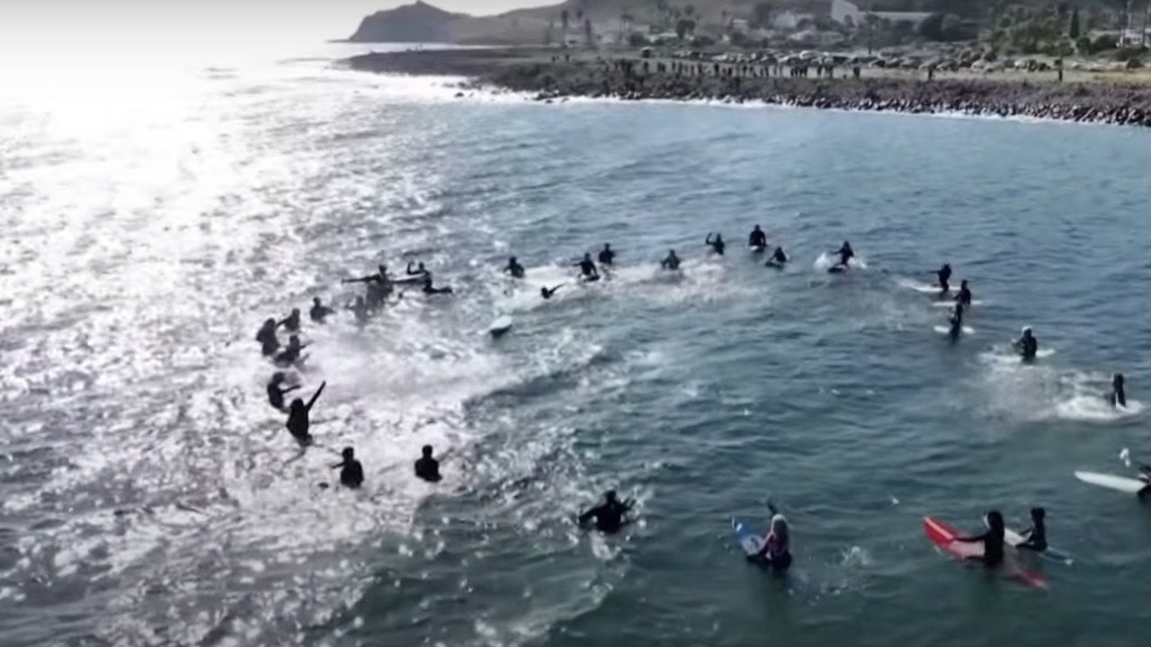 Local surfers paddled out in an emotional tribute to the surfers. Picture: YouTube