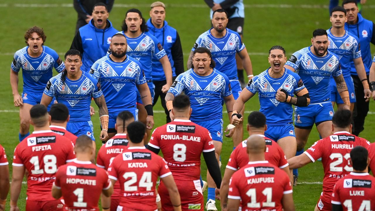 WARRINGTON, ENGLAND - NOVEMBER 06: Players of Tonga perform the Sipi Tau and Players of Samoa perform the Siva Tau ahead of the Rugby League World Cup Quarter Final match between Tonga and Samoa at The Halliwell Jones Stadium on November 06, 2022 in Warrington, England. (Photo by Gareth Copley/Getty Images)