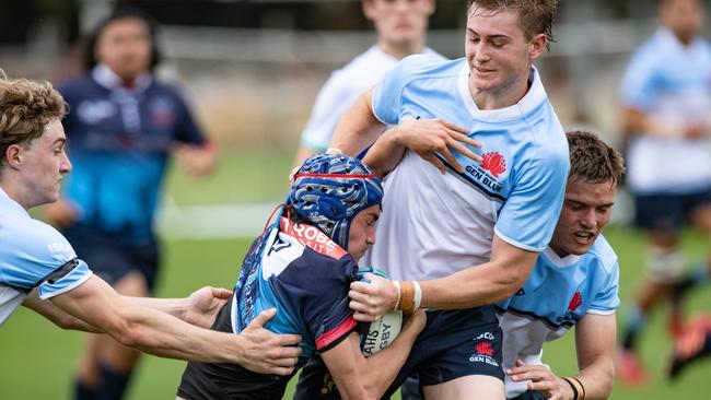 Leo Jaques and Charlie Poynton tackle Tainui Whakaari in the National U16 round three match between teenagers from the NSW Waratahs Gen Blue program and Melbourne Rebels at Daceyville. Pics: Julian Andrews