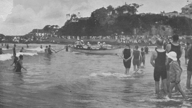 Members of the Sly family bringing Manly Council's surfboat to shore. Picture Northern Beaches Library