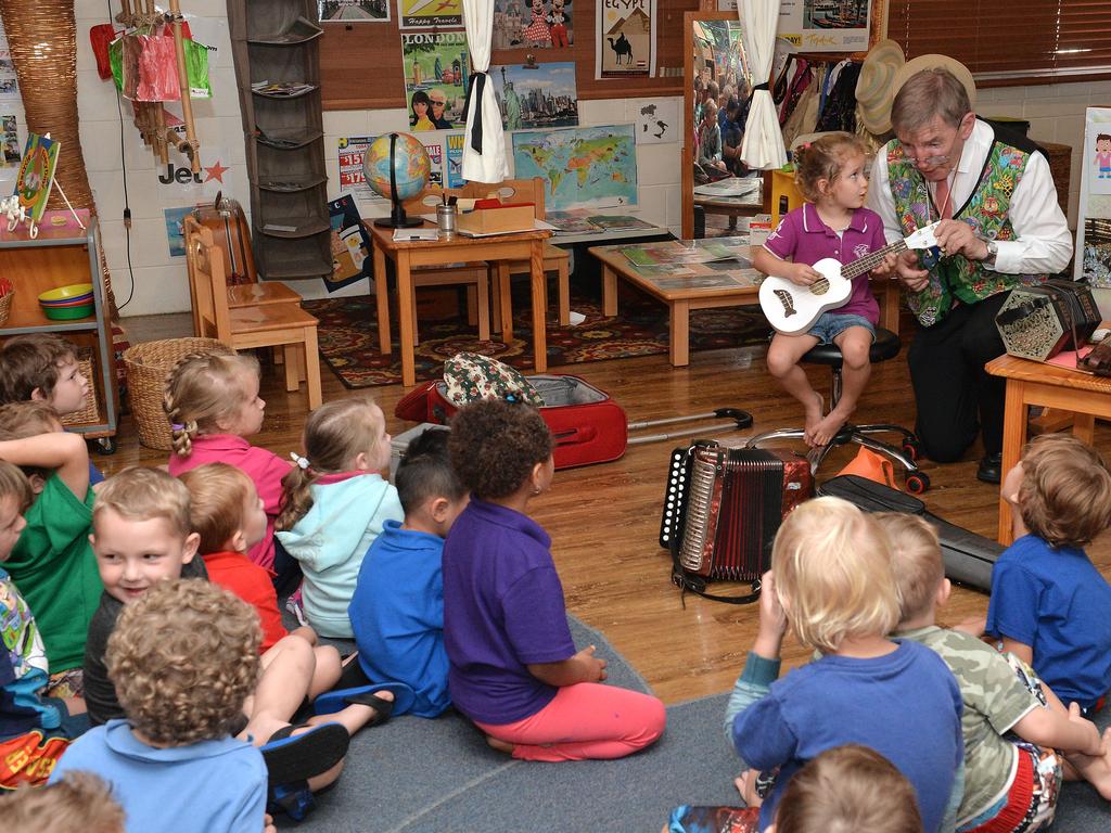 Arlow Bometti helps Mike Jackson on stage at the Pioneer Community Kindergarten.