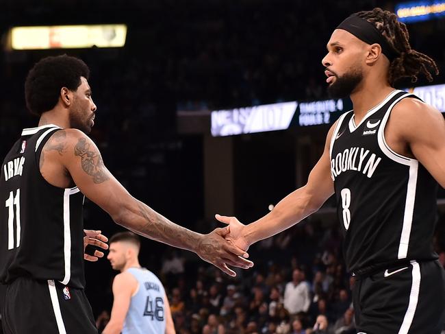 MEMPHIS, TENNESSEE - MARCH 23: Kyrie Irving #11 of the Brooklyn Nets and Patty Mills #8 of the Brooklyn Nets during the second half against the Memphis Grizzlies at FedExForum on March 23, 2022 in Memphis, Tennessee. NOTE TO USER: User expressly acknowledges and agrees that , by downloading and or using this photograph, User is consenting to the terms and conditions of the Getty Images License Agreement. (Photo by Justin Ford/Getty Images)