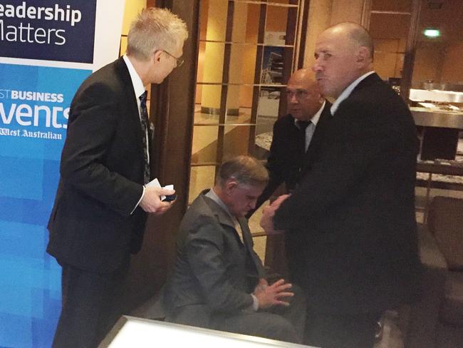 A man is detained by security after throwing a pie at Qantas CEO Alan Joyce during a speech at a business breakfast at the Hyatt Regency Perth. Picture: AAP