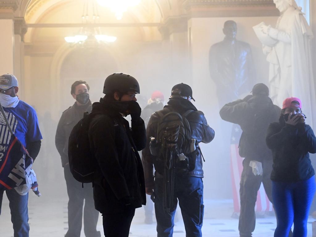 Rioters enter the US Capitol as tear gas fills the corridor. Picture: AFP