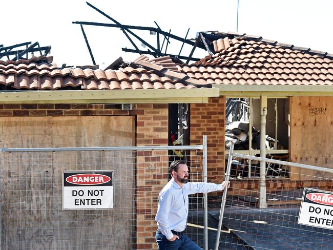 SUNDAY TELEGRAPH/AAP. First National Real Estate Agent Philip Martin poses during a photo shoot at his burnt-out property listing at Berkeley Vale on the Central Coast on Friday, May 14. The property was a drug lab that burnt down and is set to go to auction in June. AAP IMAGE / Troy Snook)