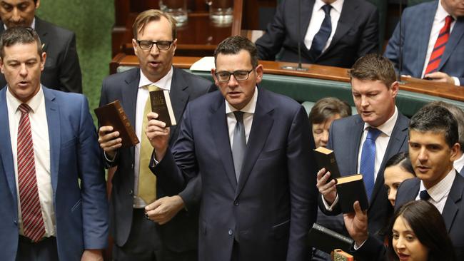 Premier Daniel Andrews (middle) and other MPs are sworn in at the opening of the 59th Parliament. Picture: David Crosling (AAP)